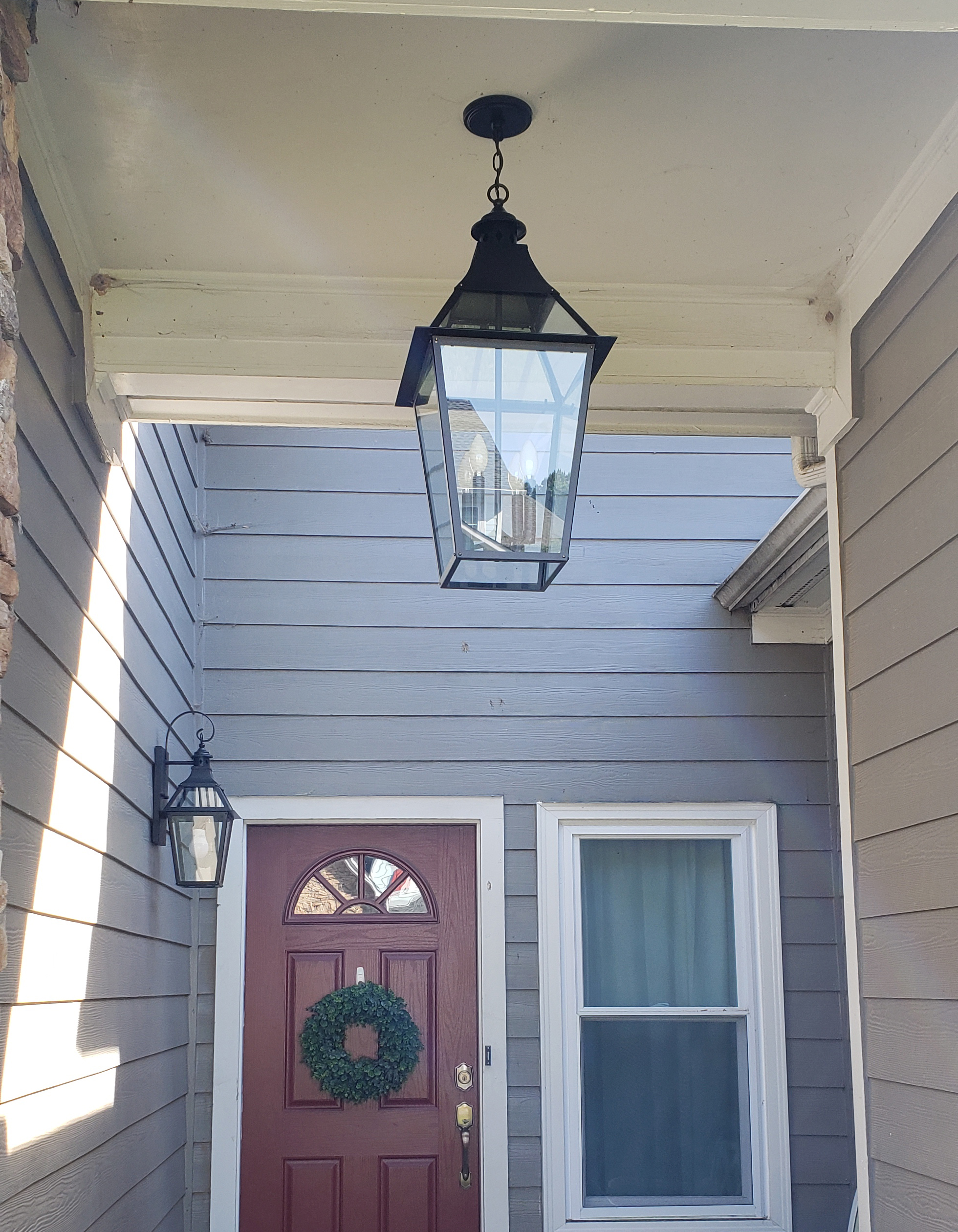 After: A large-scale hanging lantern and smaller wall-mounted lantern, all in black with traditional style. - Lighting Makeover: Our Lights in a Real Home (My Home!) - LightsOnline.com Blog